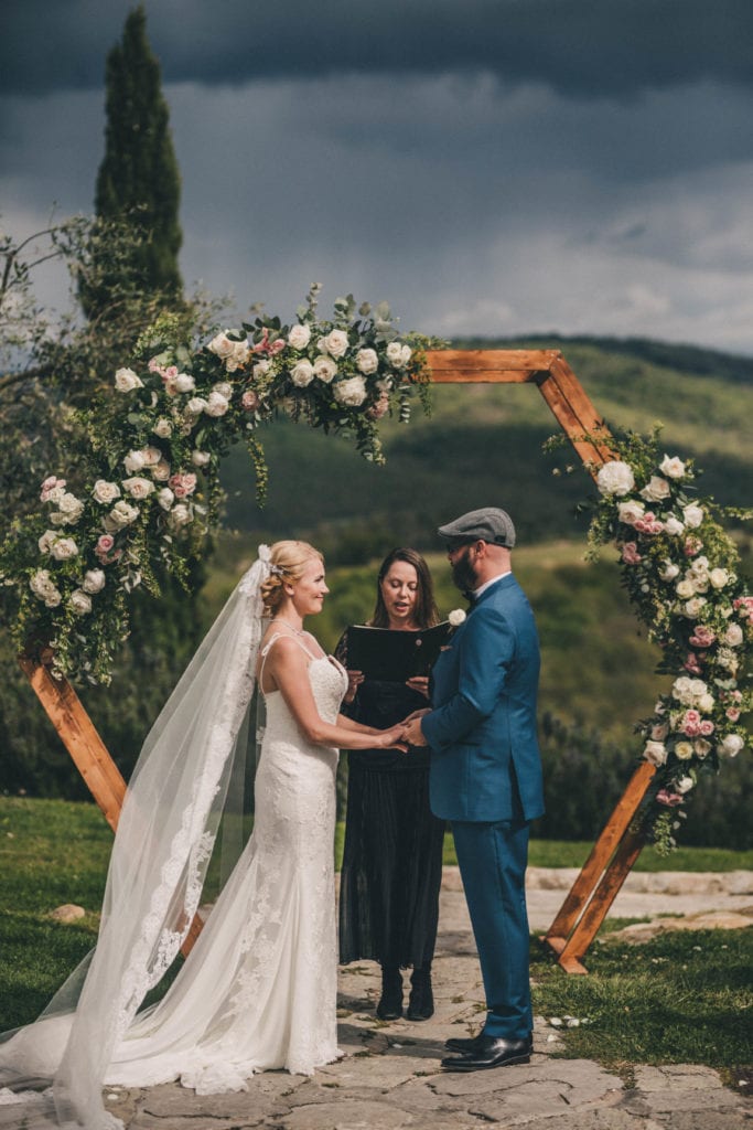 Symbolic wedding ceremony in Tuscany bride and groom with hexagon wedding arch.