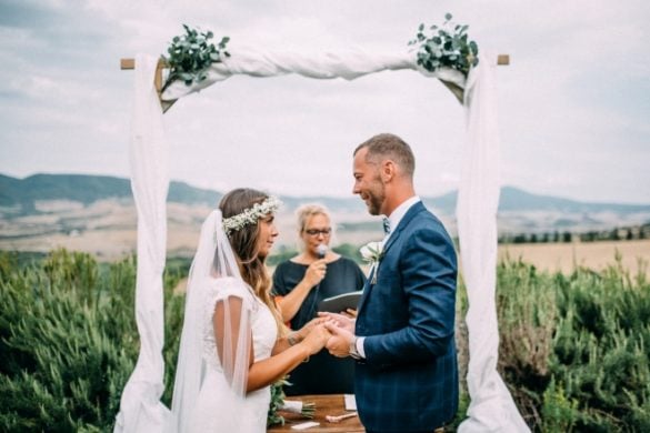 Spouses and celebrant at outdoor symbolic wedding rite