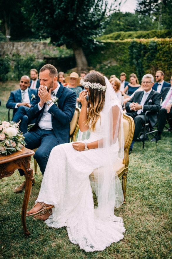 Emotional wedding couple during symbolic ceremony.