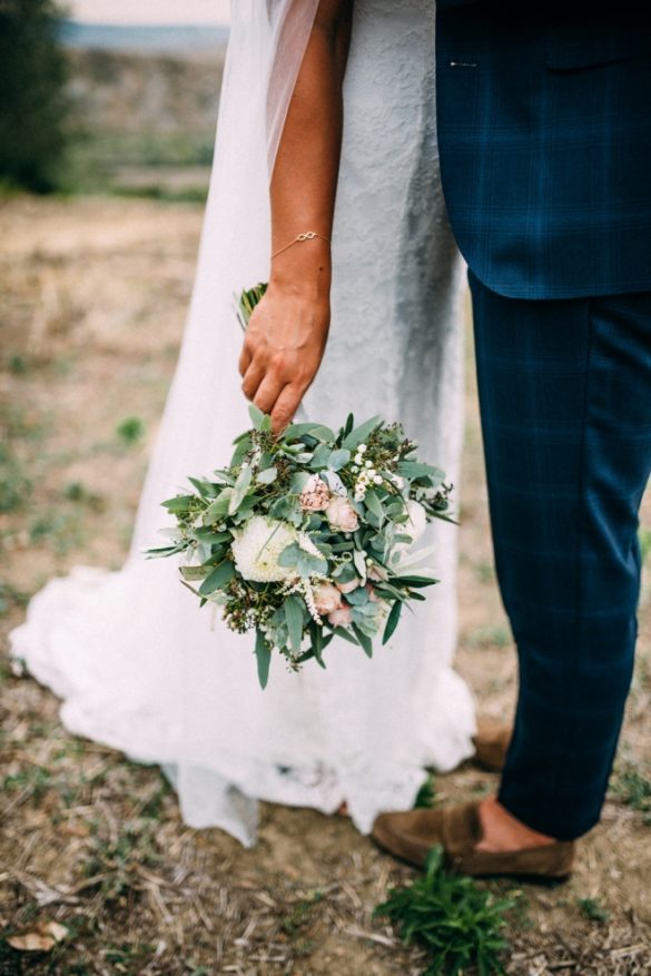 Bohemian spouses with blush wedding bouquet