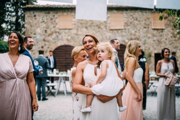 Wedding guests having a good time before dinner, blush pastel dresses