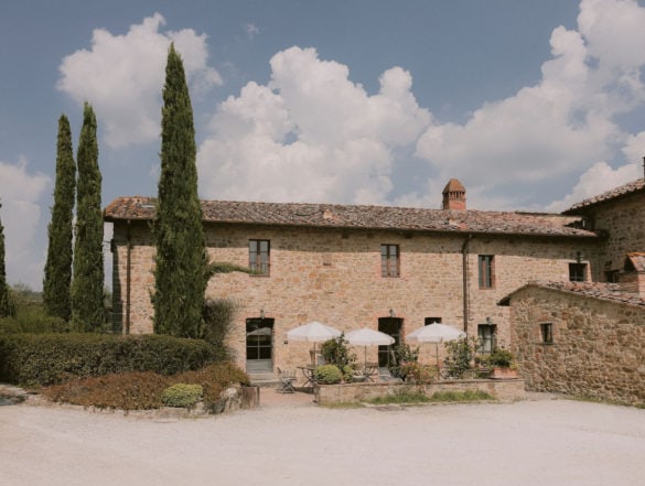 The agriturismo at the beginning of the wedding day, perfect blu sky with clouds and pretty cypresses.