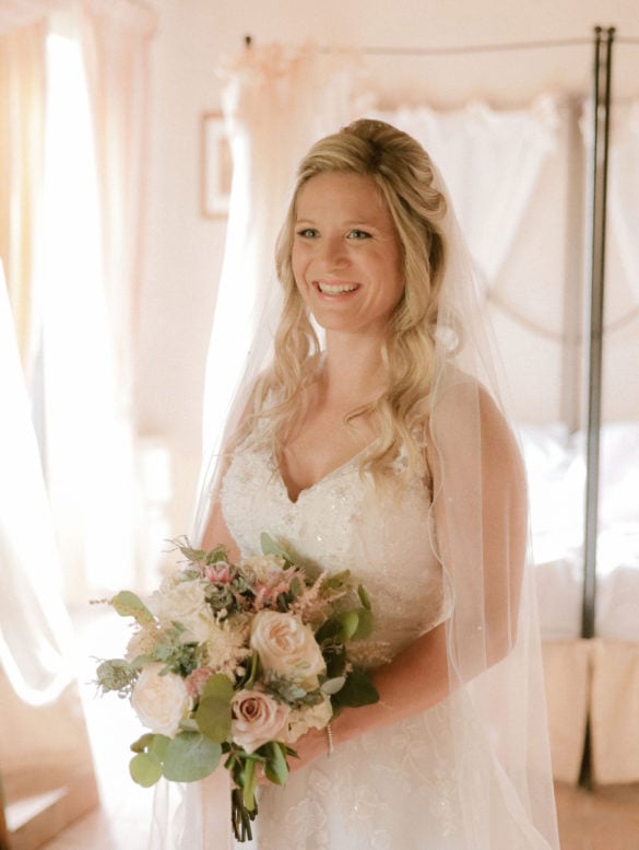 Bride receives her bouquet in blush tones with eucalyptus, astilbe and roses.