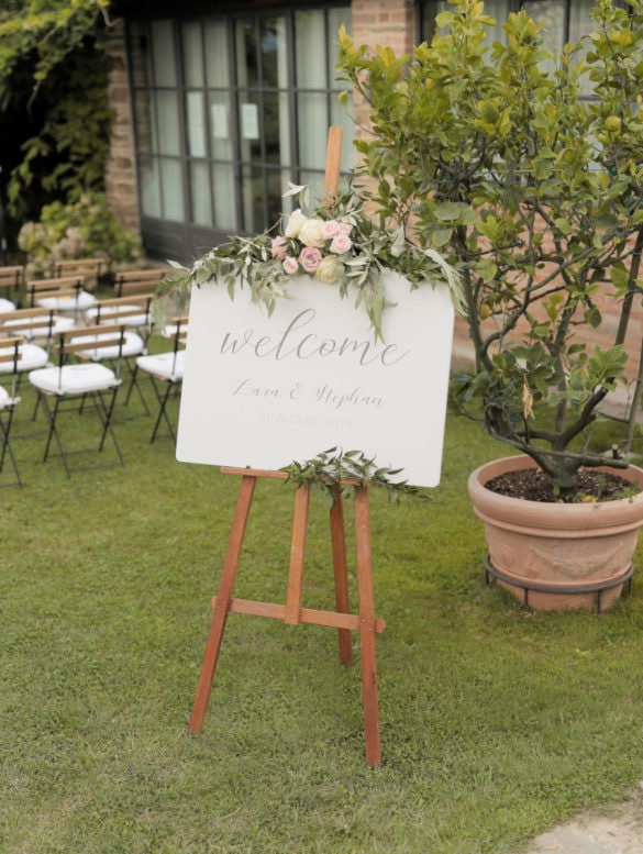 Welcome sign ceremony in blush tones with eucalyptus, olive leaves and roses.