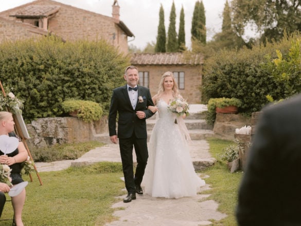 Arrival of the bride with her father at outdoor garden wedding Siena agriturismo.