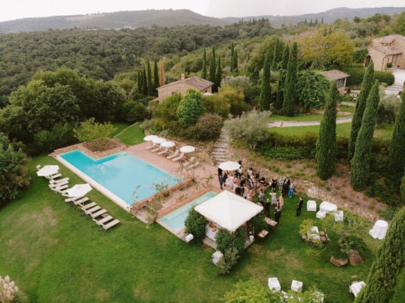 Drone photo shot from stunning garden wedding aperitif at the pool in Tuscany.