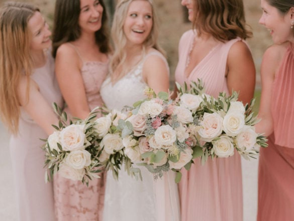 Bride with bridesmaids and their splendid bouquets in soft blush colors.