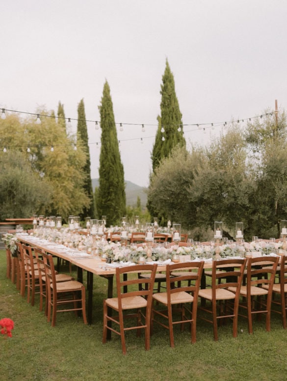 Elegant outdoor wedding table setting in white, blush and soft green in olive grove.