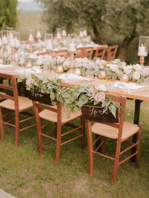 Wedding dinner decoration with candles and blush colored flowers.