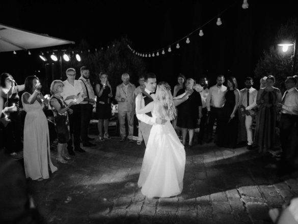 Bride and groom dance at outdoor wedding party.