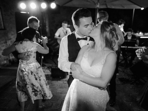 Bridal couple kisses at wedding party