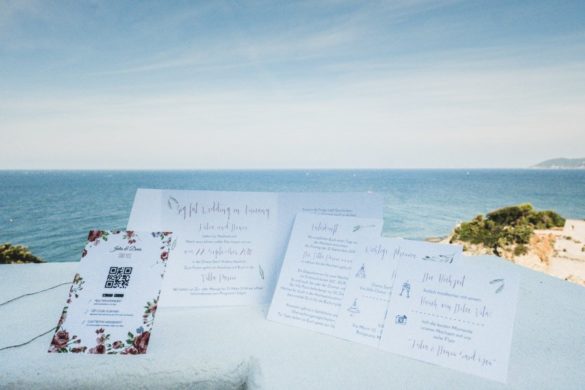 Wedding invitation and wedding menu layed out at Tuscan wedding villa with sea view.