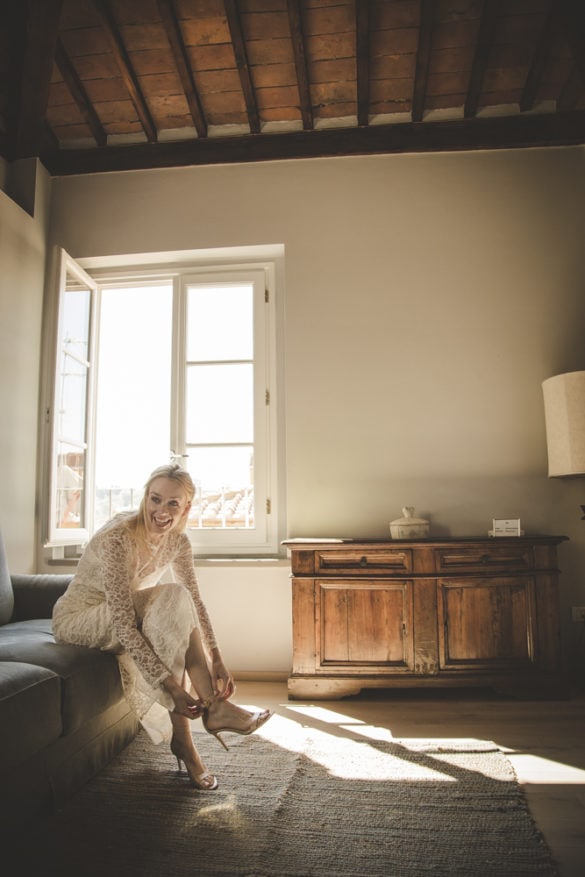 Bride getting ready last details wedding shoes