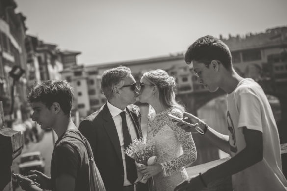 Wedding couple kissing with Ponte Vecchio in the back, Florence