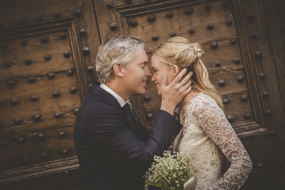 Groom touches the face of his bride in the streets of Florence