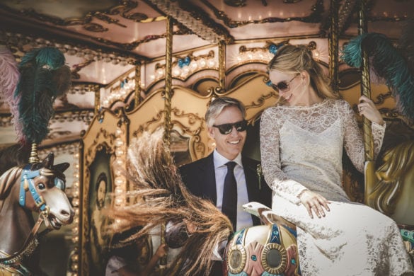 Joyful photo of wedding couple having fun in carousel