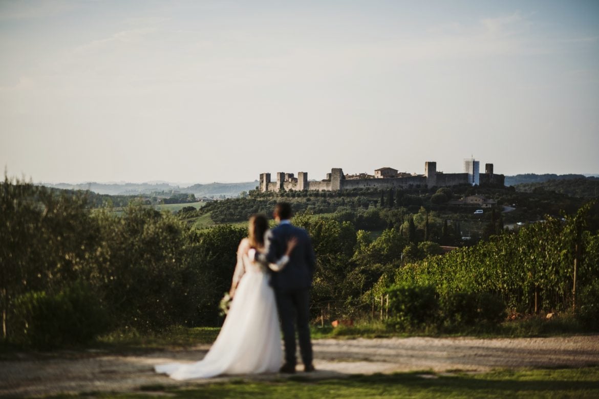 Wedding couple enjoys panoramic view from wedding location on stunning countryside