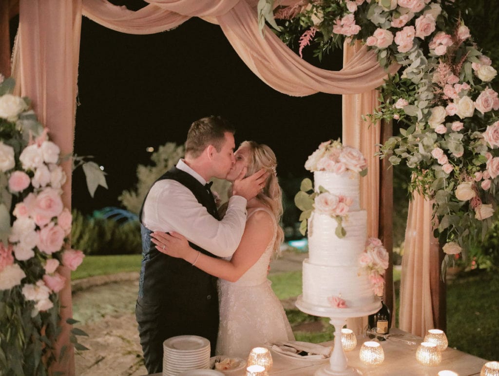 Romantic tier wedding cake with blush colored flowers